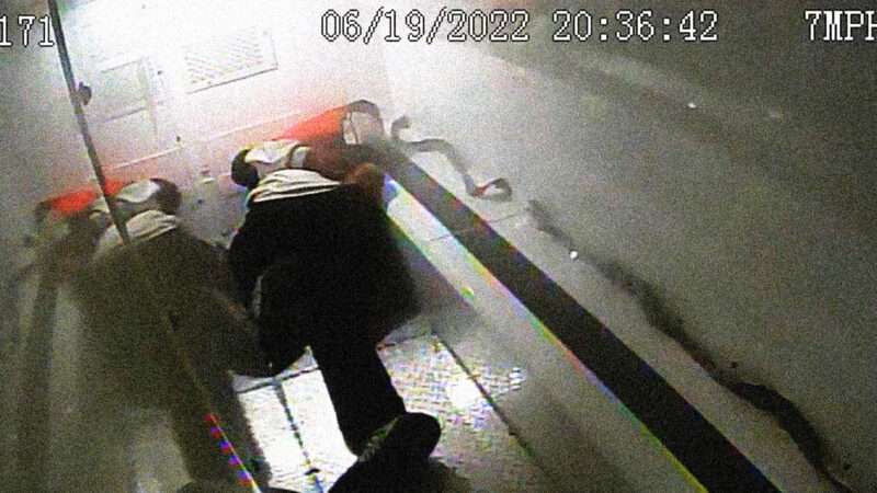 Image of Randy Cox lying on the floor of a police van.