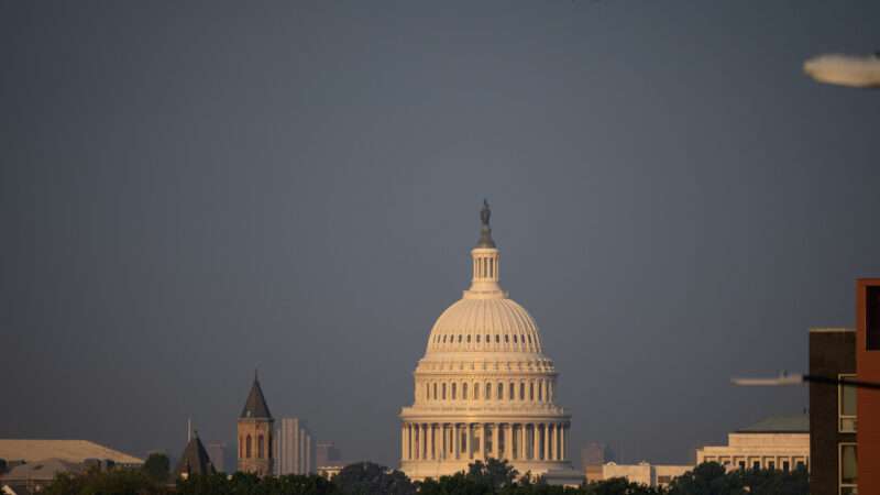 Dome of the US Capitol building with a dusky blue sky behind it