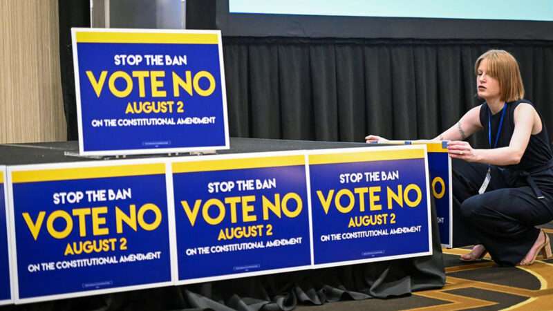 Woman putting up 'Vote No' signs in Kansas to "stop the ban" on abortion | Tammy Ljungblad/TNS/Newscom