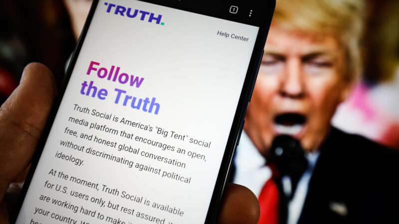 Truth Social app in front of a picture of Donald Trump | Jaap Arriens/Sipa USA/Newscom