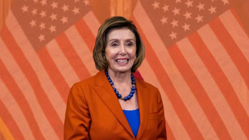 Spekaer of the House Nancy Pelosi in front of American flags