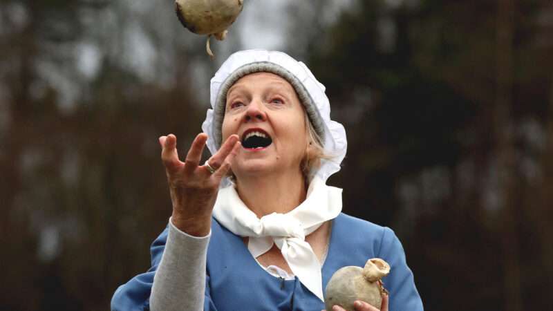 Woman in old timey clothes hurling haggis | Andrew Milligan/ZUMA Press/Newscom