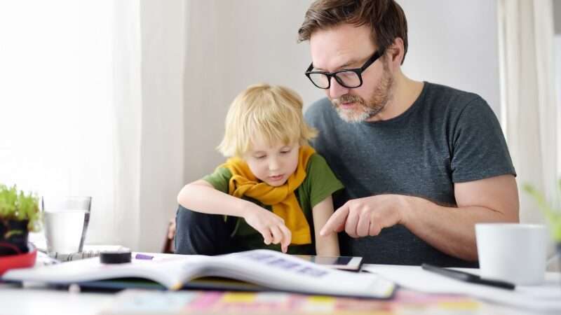 A father homeschooling his child