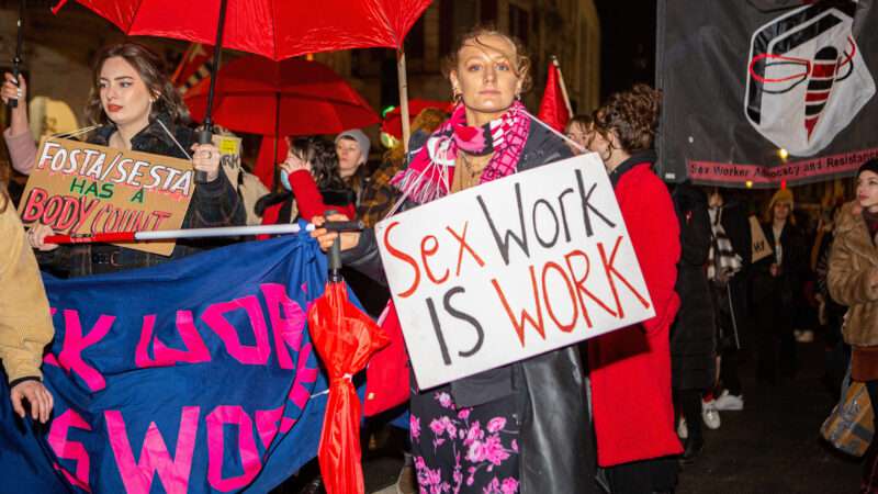 sex worker rights protest with people holding signs that say "FOSTA SESTA has a body count" and "sex work is work" | Pietro Recchia/ZUMAPRESS/Newscom