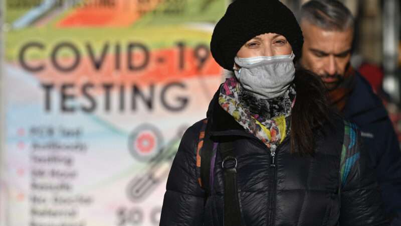 Woman wearing mask | Anthony Behar/Sipa USA/Newscom