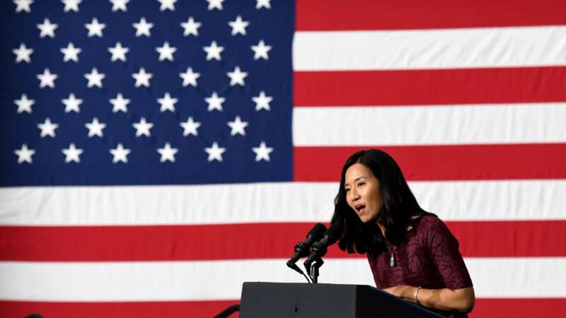 Boston's Mayor Wu speaks at podium in front of American flag background | Mark Stockwell - Pool via CNP/CNP / Polaris/Newscom