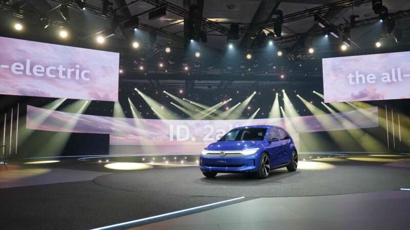 Volkswagen's ID.2all electric hatchback concept car sits onstage at an event in Hamburg, Germany.