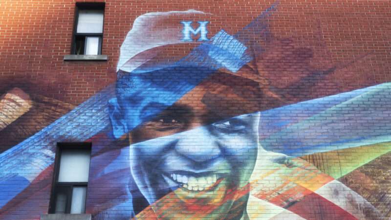 A Jackie Robinson graffiti mural on a brick wall in Montreal.