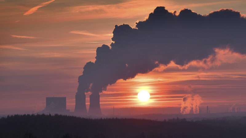 A sunset, depicting the outline of the billowing smokestacks of a coal-fired power plant just south of Liepzig, Germany. | FrankHoemann/SVEN SIMON/picture alliance / SvenSimon/Newscom