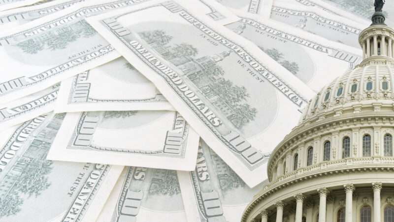 The US Capitol is seen next to $100 bills