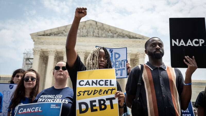 A woman hold a 'cancel student debt' sign at a protest | Allison Bailey/ZUMAPRESS/Newscom