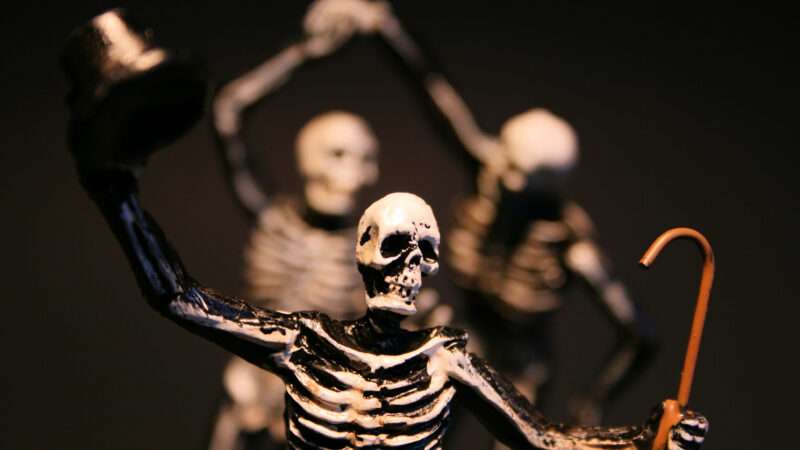 Three Halloween skeletons posed to look like they're dancing. | Julia Gatewood | Dreamstime.com