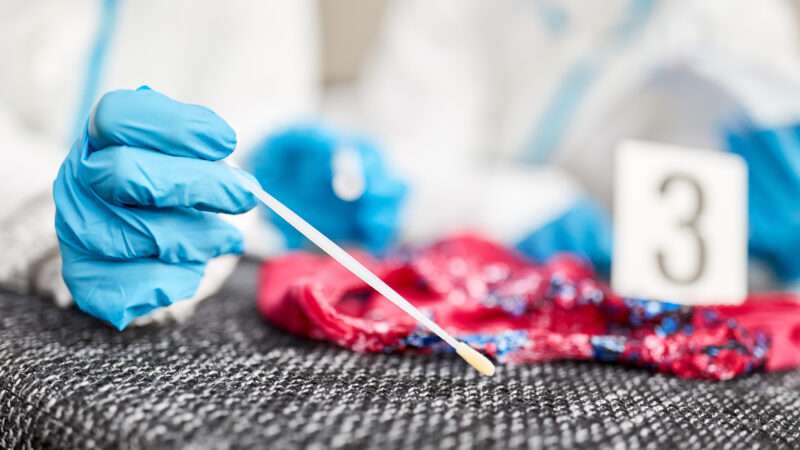 A forensic scientist takes a DNA sample. | Robert Kneschke | Dreamstime.com