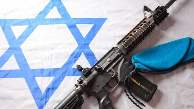 An M4 carbine against an Israeli flag. | NayalyH/Newscom
