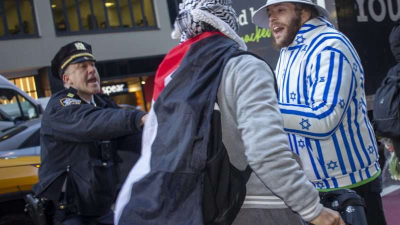 NYPD officer tries to break up clash between Israel-Hamas protesters | John Marshall Mantel/ZUMAPRESS/Newscom