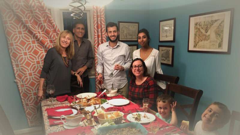 A family and their au pair around a Thanksgiving table | Alex Nowrasteh