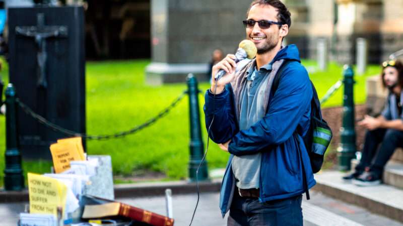 A street preacher speaks into a microphone. | Adam Calaitzis | Dreamstime.com