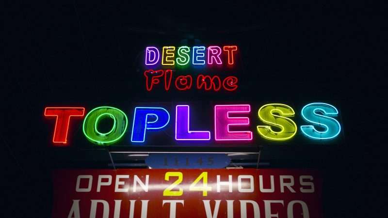 Neon signs reading TOPLESS, advertising a topless bar. | Joe Sohm | Dreamstime.com