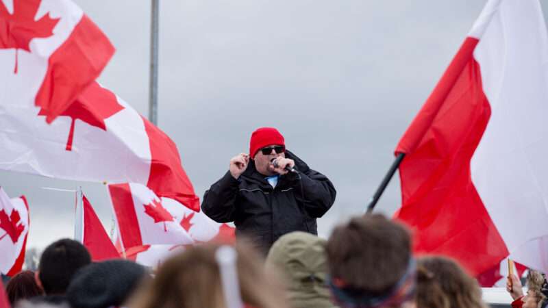 A man addresses a crowd waving Canadian flags, in protest of COVID-19 vaccine mandates. | Ryan Walter Wagner/ZUMAPRESS/Newscom