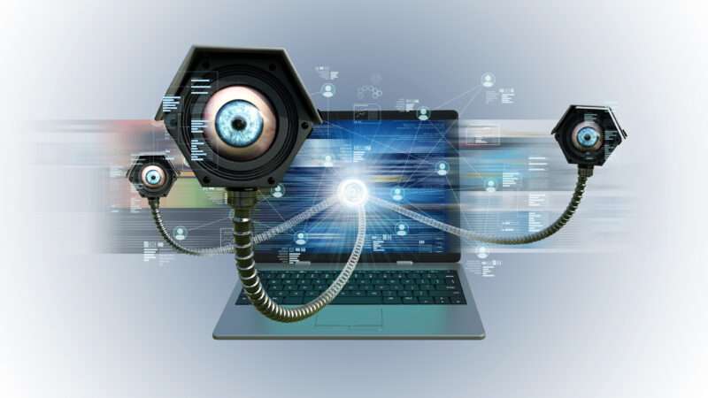 Cameras with eyeballs come out of a laptop, signifying that your browsing history is spying on you. | Nmedia | Dreamstime.com