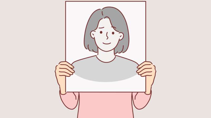 person holding a picture of a face in front of their real face | ALPHAVECTOR/Newscom