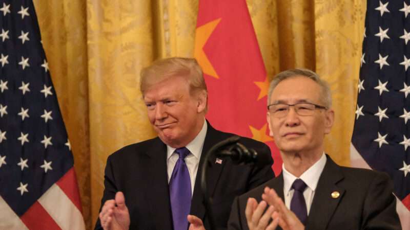 Donald Trump in front of Chinese flag | Alex Wroblewski/CNP/AdMedia/Newscom