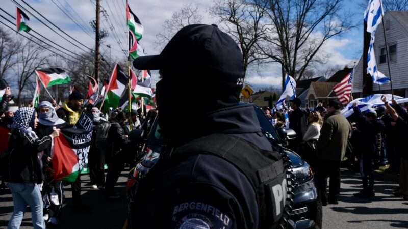 A police officer stands between pro-Palestinian and pro-Israeli protesters in Teaneck, New Jersey on March 10, 2024. | Matthew Petti