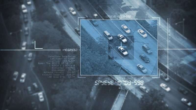 An overhead surveillance shot of a car in traffic, as captured by a drone, helicopter, or satellite. | Welcomia | Dreamstime.com