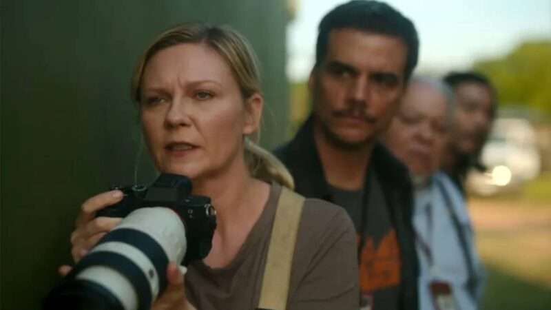 A still from the movie "Civil War" of Kirsten Dunst holding a camera | A24/Civil War