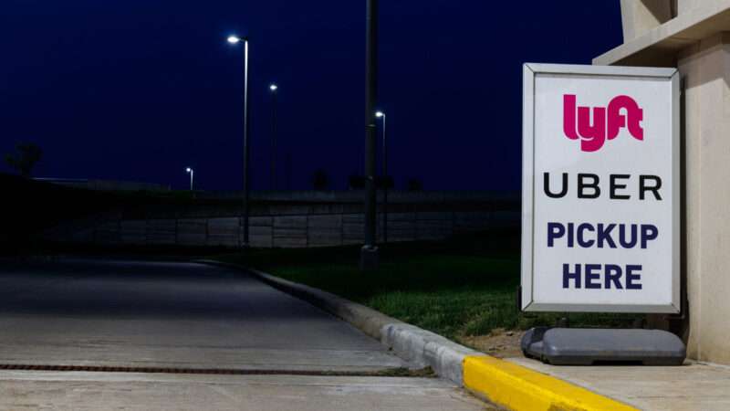 Sign on a dark, empty street reads, "Lyft, Uber pickup here." | Photo 150010020 © Jonathan Weiss | Dreamstime.com