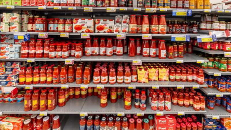 Supermarket shelves with many different tomato products in cans and jars. | Francesco Marzovillo | Dreamstime.com