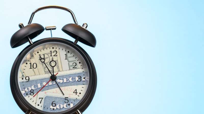 an alarm clock with social security card on the face | Photo 122539429 © Steveheap | Dreamstime.com