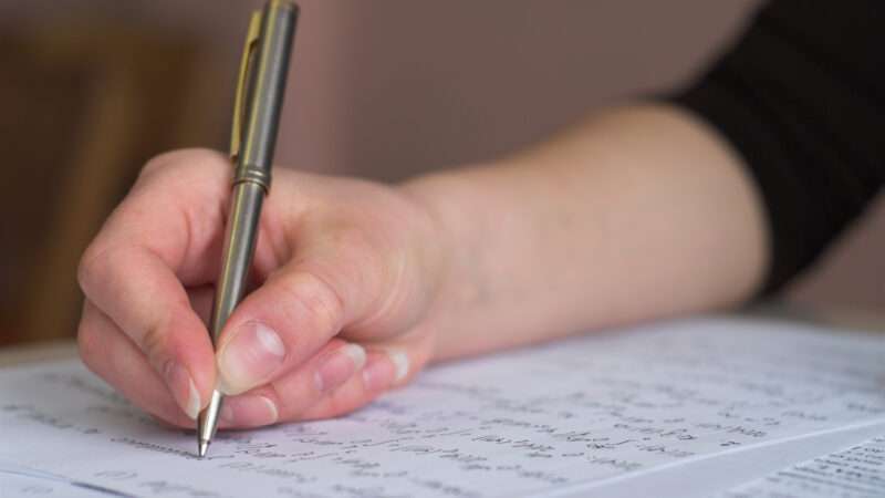 Close-up of a student's hand taking a test. | Petro | Dreamstime.com