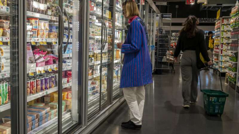 Shopper stares at frozen food in a grocery store aisle | Richard B. Levine/Newscom