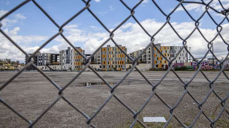 Housing as seen through a chain link fence |  Peter Bennett/Citizen of the Planet/Universal Images Group/Newscom