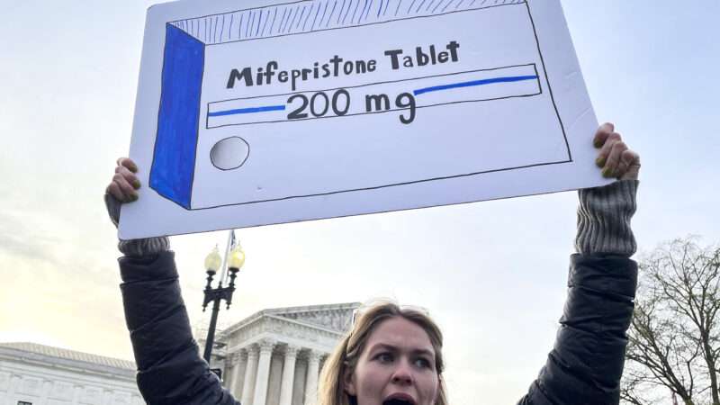 A sign is held at an abortion pill protest | Sue Dorfman/ZUMAPRESS/Newscom