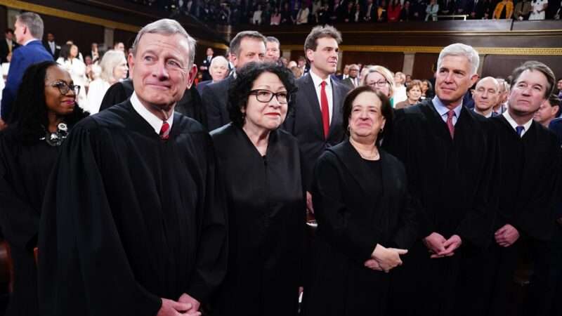 Supreme Court Justices Ketanji Brown Jackson, John Roberts, Sonia Sotomayor, Elena Kagan, Neil Gorsuch, and Brett Kavanaugh standing in a line. | CNP/AdMedia/Newscom