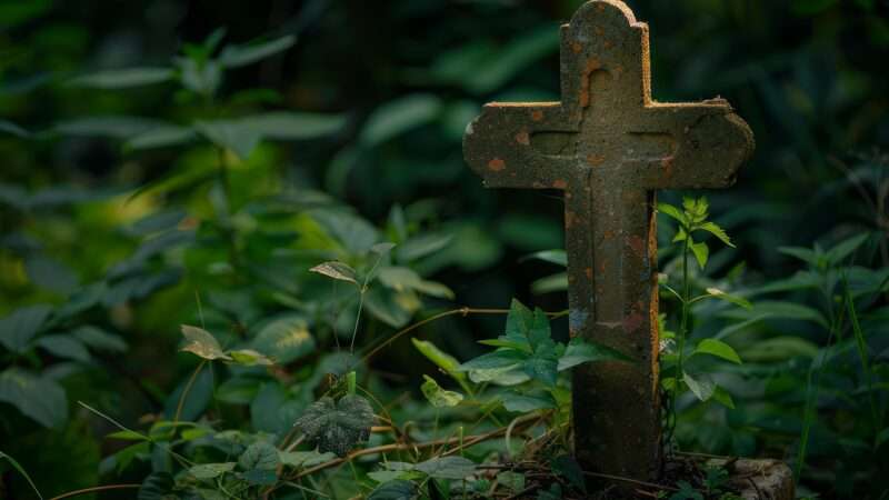 Ancient stone burial marker in the shape of a cross | Ylivdesign | Dreamstime.com 