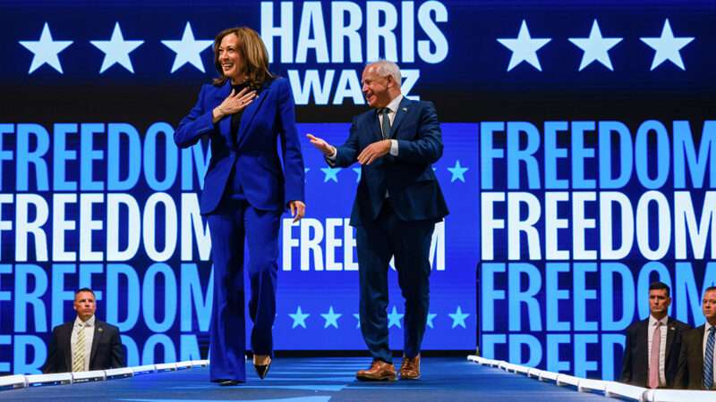 Kamala Harris and Tim Walz standing on a stage in front of a backdrop that says "Freedom" | Photo: Jeffrey Phelps/Associated Press