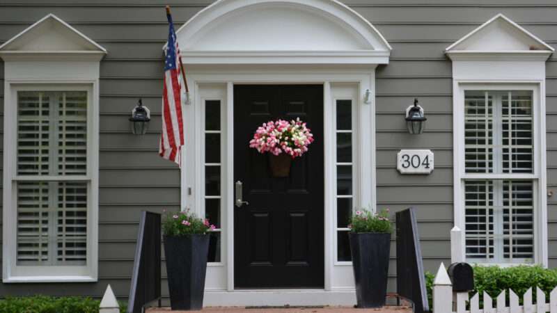 Front door with an American flag | ID 108607198 © | Dreamstime.com