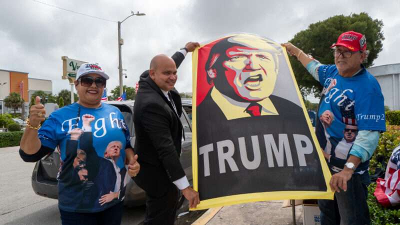 People holding up a poster of Trump | Alberto E. Tamargo/Sipa USA/Newscom