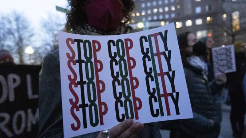 A protester holding a sign that reads "STOP COP CITY" | Gina M Randazzo/ZUMAPRESS/Newscom