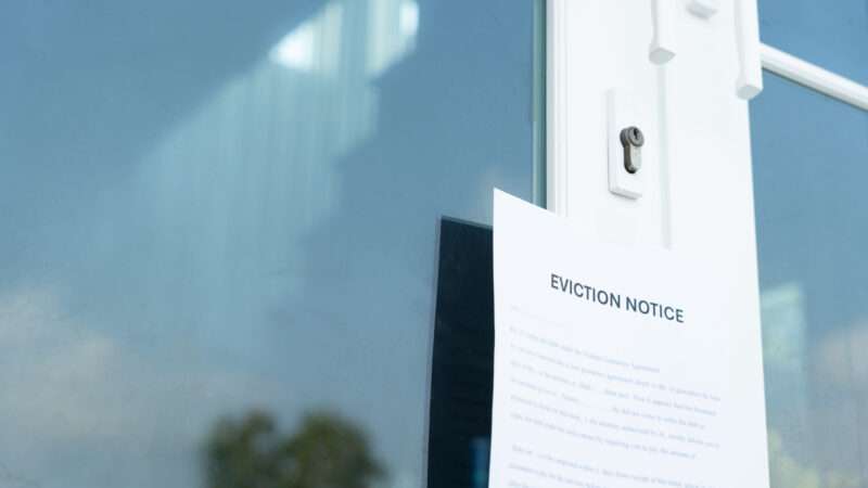 Storm door with an eviction notice attached to the front. | Chaiyan Anuwatmongkonchai | Dreamstime.com