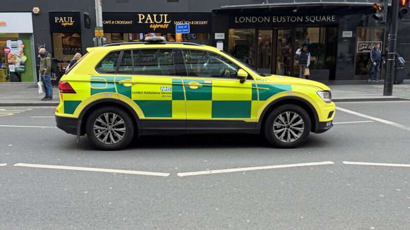 An SUV bearing the design and logos of the National Health Service (NHS), on a London street. | Jarretera | Dreamstime.com