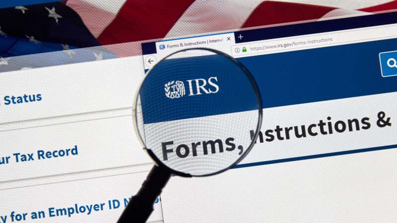 The IRS website is seen with a magnifying glass over the IRS logo | ID 146134876 | American Flag © Dennizn | Dreamstime.com