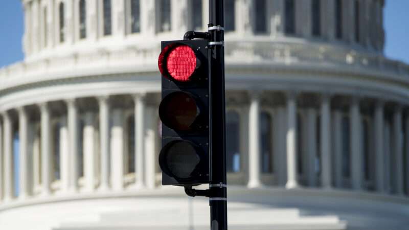 Red traffic light in front of the U.S. Capitol Building | Bill Clark/CQ Roll Call/Newscom