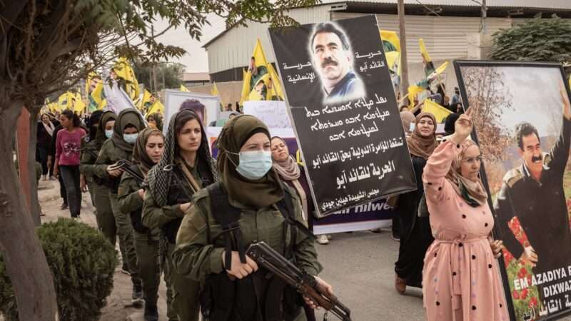 Kurdish militia members guard a protest against Turkish attacks in Raqqa, Syria. October 9, 2023. | Chris Huby/ZUMAPRESS/Newscom