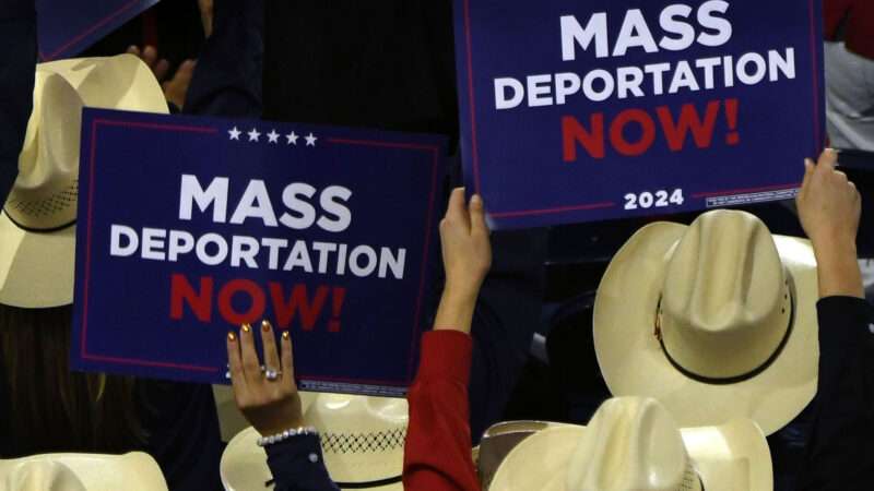 People hold up "mass deportation now" signs at the 2024 Republican National Convention. | Carol Guzy/ZUMAPRESS/Newscom