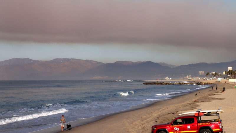 Los Angeles beach with smoke from wildfires in the distance | Jonathan Alcorn/ZUMAPRESS/Newscom