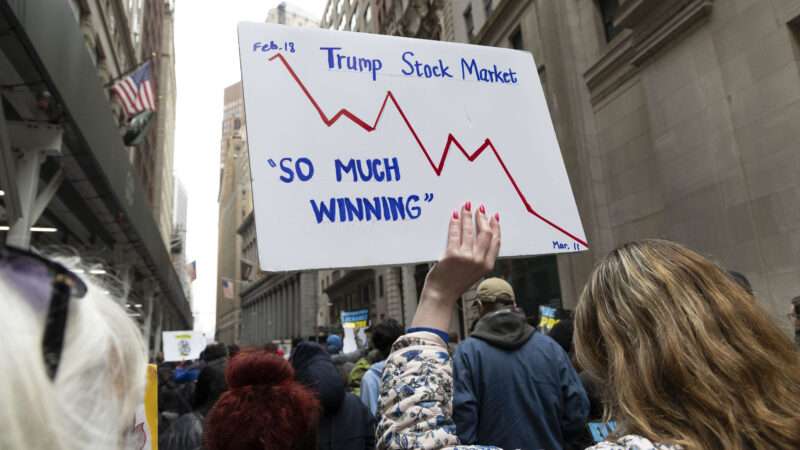 A protestor's sign reading "so much winning" next to a negative stock market graph | Gina M Randazzo/ZUMAPRESS/Newscom